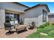 Charming backyard patio featuring comfortable seating, a fire pit, and access to the home's interior at 6145 S Adelle --, Mesa, AZ 85212