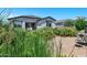 Spacious backyard with patio area, lush landscaping and exterior view of the house at 6145 S Adelle --, Mesa, AZ 85212