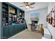 Cozy bedroom features a ceiling fan, neutral carpet, a bookcase, and a bright window at 6145 S Adelle --, Mesa, AZ 85212