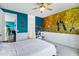 View of the bedroom featuring accent wall with wainscotting, a ceiling fan and ensuite bathroom at 6145 S Adelle --, Mesa, AZ 85212