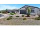 Well-maintained single-story homes, with desert landscaping, grey garages and a welcoming neighborhood street at 6145 S Adelle --, Mesa, AZ 85212