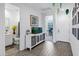 Inviting hallway featuring light wood floors and leads to a bathroom and office at 6145 S Adelle --, Mesa, AZ 85212