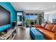 Stylish living room with modern furniture, vibrant blue wall, and sliding glass doors to the outside at 6145 S Adelle --, Mesa, AZ 85212