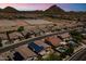Beautiful aerial view of a neighborhood showcasing homes with solar panels, private pools, and desert landscapes at 6213 W Gambit Trl, Phoenix, AZ 85083