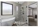 Contemporary bathroom with a freestanding tub and glass enclosed shower showcasing natural light from the window at 6213 W Gambit Trl, Phoenix, AZ 85083