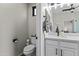 A well-lit powder room featuring sleek fixtures, a modern vanity, and a convenient toilet area at 6213 W Gambit Trl, Phoenix, AZ 85083