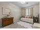 Bright bedroom with a metal framed bed, cozy textures, and a window providing natural light at 6213 W Gambit Trl, Phoenix, AZ 85083