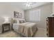 Comfortable bedroom with neutral tones featuring a well-made bed and ample natural light from the window at 6213 W Gambit Trl, Phoenix, AZ 85083