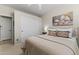 Cozy bedroom space featuring a comfortable bed, neutral tones, and closet storage at 6213 W Gambit Trl, Phoenix, AZ 85083