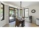 Sunlit dining area features tile floors, black chandelier, and patio access at 6213 W Gambit Trl, Phoenix, AZ 85083