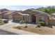 Full frontal view of a home with desert landscaping, two-car garage and neutral stucco siding at 6213 W Gambit Trl, Phoenix, AZ 85083