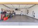 Spacious three-car garage featuring a epoxy flooring, ample storage cabinets and a well-organized tool section for convenience at 6213 W Gambit Trl, Phoenix, AZ 85083