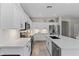 Updated kitchen featuring white cabinets, stainless steel appliances, island and tile flooring at 6213 W Gambit Trl, Phoenix, AZ 85083