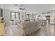 Open-concept living area with tile floors, and a kitchen with white cabinetry at 6213 W Gambit Trl, Phoenix, AZ 85083