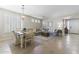 Comfortable living area with tile flooring, neutral-toned furniture and dining table with chandelier at 6213 W Gambit Trl, Phoenix, AZ 85083
