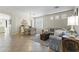 Open living area with tiled floors, comfortable sofas, a dining table, and natural light at 6213 W Gambit Trl, Phoenix, AZ 85083