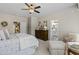 Serene main bedroom with ceiling fan and en-suite bathroom access at 6213 W Gambit Trl, Phoenix, AZ 85083