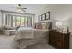 Cozy main bedroom with bay window, ceiling fan, and accent chair at 6213 W Gambit Trl, Phoenix, AZ 85083
