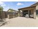 Charming covered patio with a built-in grill station, comfortable seating, and elegant string lights for outdoor entertaining at 6213 W Gambit Trl, Phoenix, AZ 85083