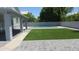 Backyard featuring large pool, artificial turf, and brick pavers for a luxurious outdoor space at 627 W Mendoza Ave, Mesa, AZ 85210