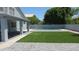 Serene backyard featuring a sparkling pool, artificial grass and patio area offering a perfect retreat at 627 W Mendoza Ave, Mesa, AZ 85210