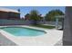 This backyard has a pristine pool and artificial grass making it a perfect space for outdoor entertaining at 627 W Mendoza Ave, Mesa, AZ 85210