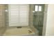 Soaking tub and frameless shower combination with window and shutter at 627 W Mendoza Ave, Mesa, AZ 85210