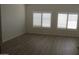 Light bedroom with white walls, wood-look flooring, and window shutters allowing natural light at 627 W Mendoza Ave, Mesa, AZ 85210