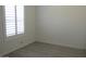 Bedroom with wood-look floors, base trim, and a window with white shutters at 627 W Mendoza Ave, Mesa, AZ 85210
