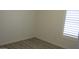 Bedroom with wood-look floors, base trim, and a window with white shutters at 627 W Mendoza Ave, Mesa, AZ 85210