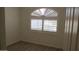 Bedroom with wood-look floors and a window with white shutters at 627 W Mendoza Ave, Mesa, AZ 85210