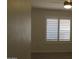 Cozy bedroom featuring neutral paint, a window with shutters, and a ceiling fan at 627 W Mendoza Ave, Mesa, AZ 85210