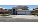 Charming two-story home featuring a light-colored exterior, tile roof, and a spacious two-car garage at 627 W Mendoza Ave, Mesa, AZ 85210