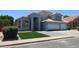 Charming two-story home featuring a two-car garage, tidy front yard, and attractive landscaping at 627 W Mendoza Ave, Mesa, AZ 85210