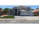 Attractive two-story home with a tile roof, three-car garage, and manicured lawn at 627 W Mendoza Ave, Mesa, AZ 85210
