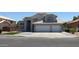Charming two-story home with a tile roof, three-car garage, and manicured lawn at 627 W Mendoza Ave, Mesa, AZ 85210