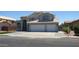 Well-maintained two-story home with a tile roof, three-car garage, and manicured lawn at 627 W Mendoza Ave, Mesa, AZ 85210