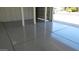 Clean garage featuring painted walls, sealed floors, and an automatic door, offering a functional space at 627 W Mendoza Ave, Mesa, AZ 85210