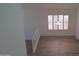 Bright living room with hardwood floors, plantation shutters, and modern light fixture at 627 W Mendoza Ave, Mesa, AZ 85210