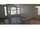 Bright living room featuring abundant natural light, white walls, wood-look flooring, and white railings at 627 W Mendoza Ave, Mesa, AZ 85210