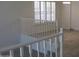 Bright staircase with wood floors and white railings leads to upstairs living spaces at 627 W Mendoza Ave, Mesa, AZ 85210