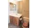 Neutral bathroom with wood vanity and toilet at 6436 W Saddlehorn Rd, Phoenix, AZ 85083