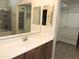 Bathroom with vanity, sink, framed mirror, and access to shower and walk-in closet at 6436 W Saddlehorn Rd, Phoenix, AZ 85083