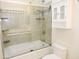 Bright bathroom features a tiled shower-over-tub with glass door and updated fixtures at 6436 W Saddlehorn Rd, Phoenix, AZ 85083
