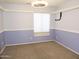Carpeted bedroom offers a cozy space with natural light at 6436 W Saddlehorn Rd, Phoenix, AZ 85083
