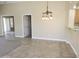 Open dining area with tile flooring and modern light fixture, adjacent to kitchen area at 6436 W Saddlehorn Rd, Phoenix, AZ 85083