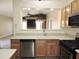 Kitchen with wooden cabinets, stainless steel appliances, and a view to the living room at 6436 W Saddlehorn Rd, Phoenix, AZ 85083