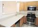 A modern kitchen with stainless steel appliances, light wood cabinetry, and a bright countertop at 6436 W Saddlehorn Rd, Phoenix, AZ 85083