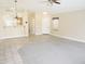 Bright living area with tile flooring, view of kitchen, and access to the front door at 6436 W Saddlehorn Rd, Phoenix, AZ 85083
