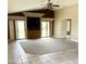Spacious living room with tile and carpet flooring and sliding door access to the pool at 6436 W Saddlehorn Rd, Phoenix, AZ 85083